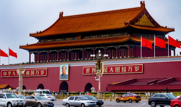 cars parked in front of red and brown building