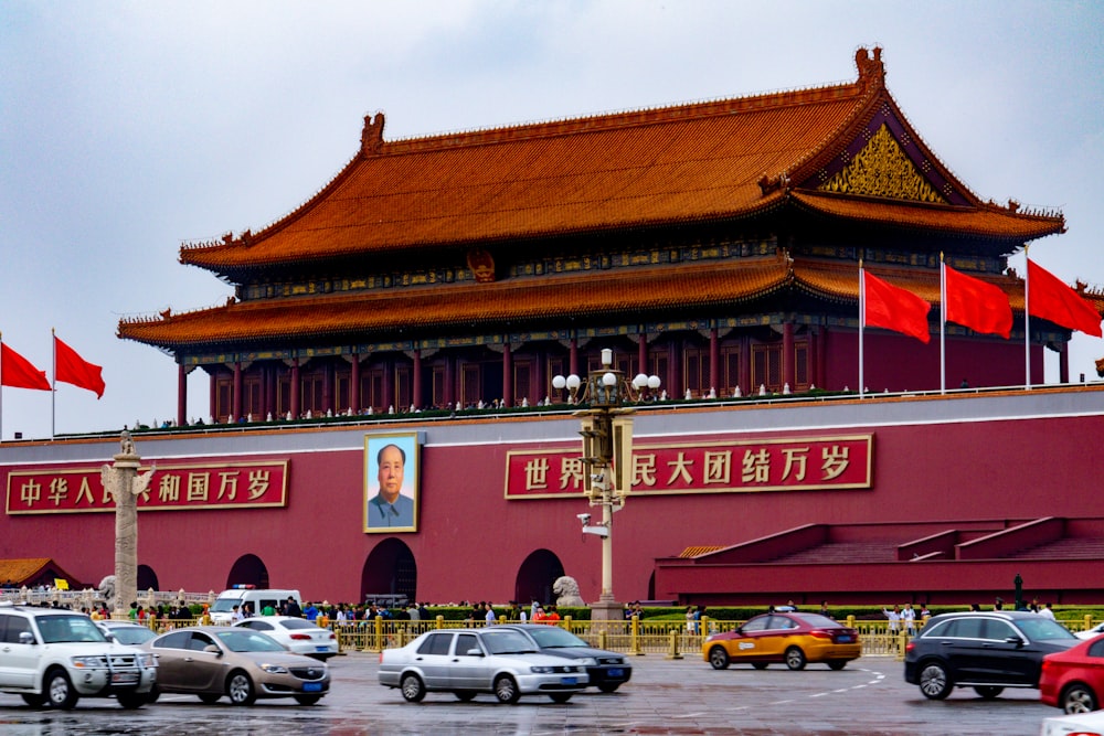 cars parked in front of red and brown building