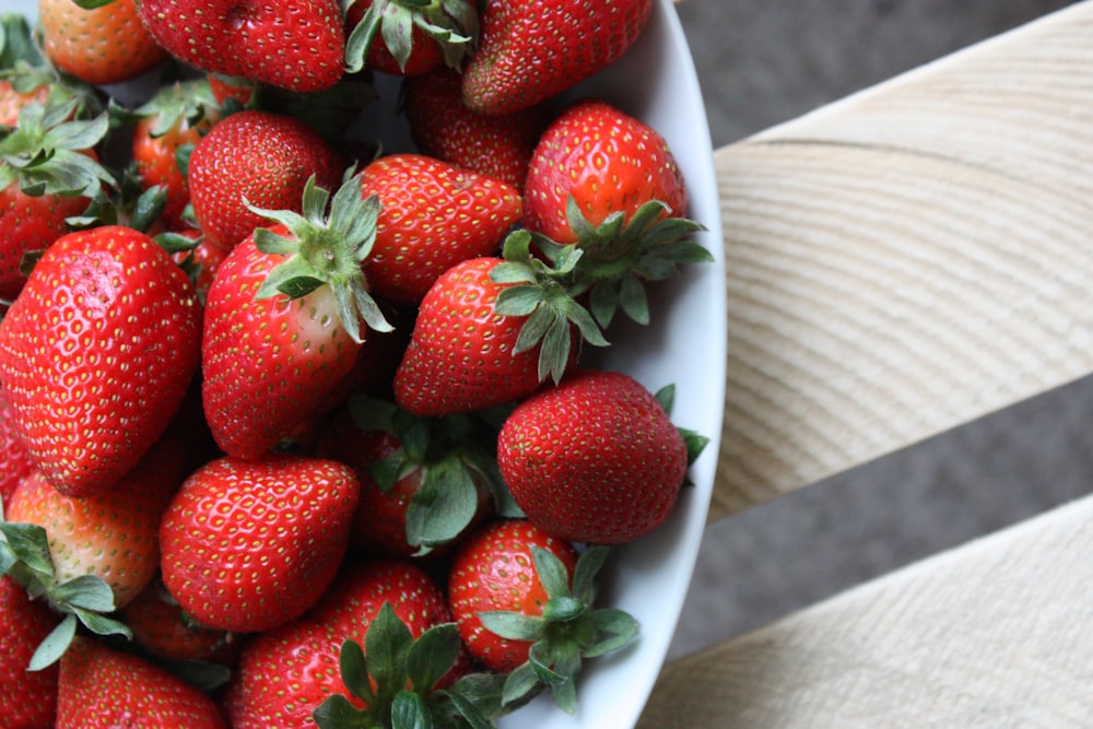 strawberries on white ceramic bowl