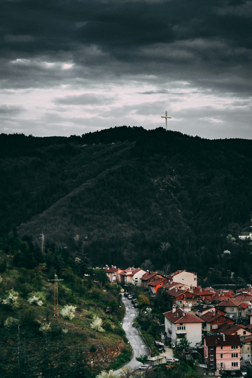 houses on mountain under cloudy sky during daytime