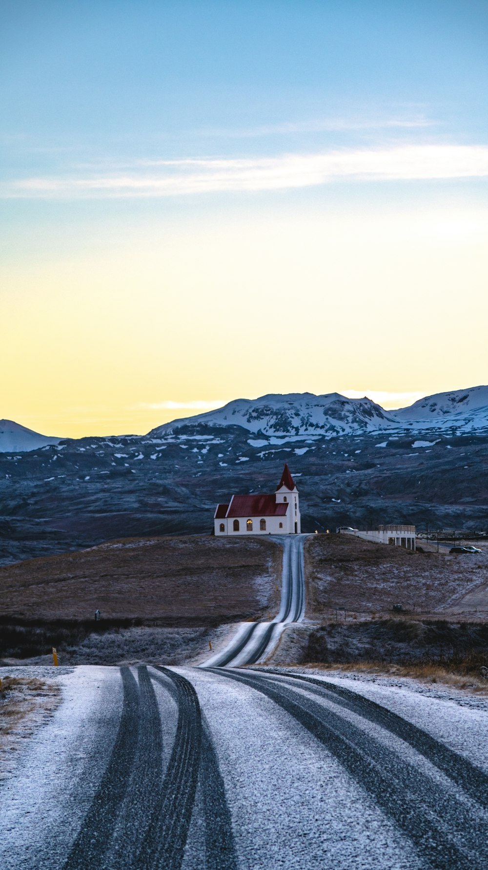 white and red house on top of hill