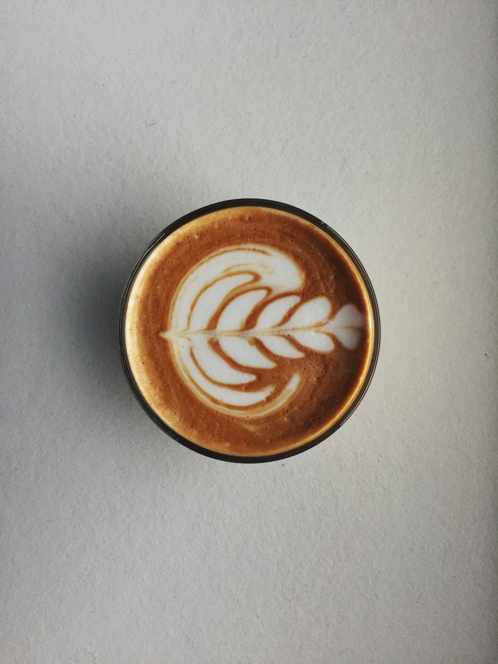 brown and white ceramic cup with brown liquid