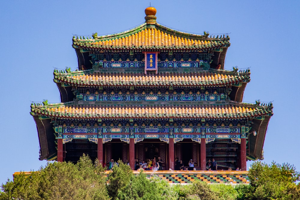 brown and green temple surrounded by green trees during daytime