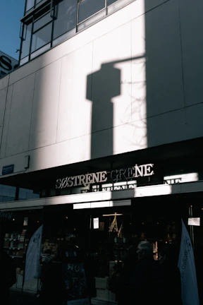 Team photo of the sveikatanova staff smiling in front of the store entrance.