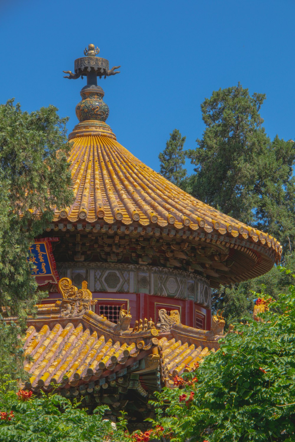 brown and red temple surrounded by green trees during daytime