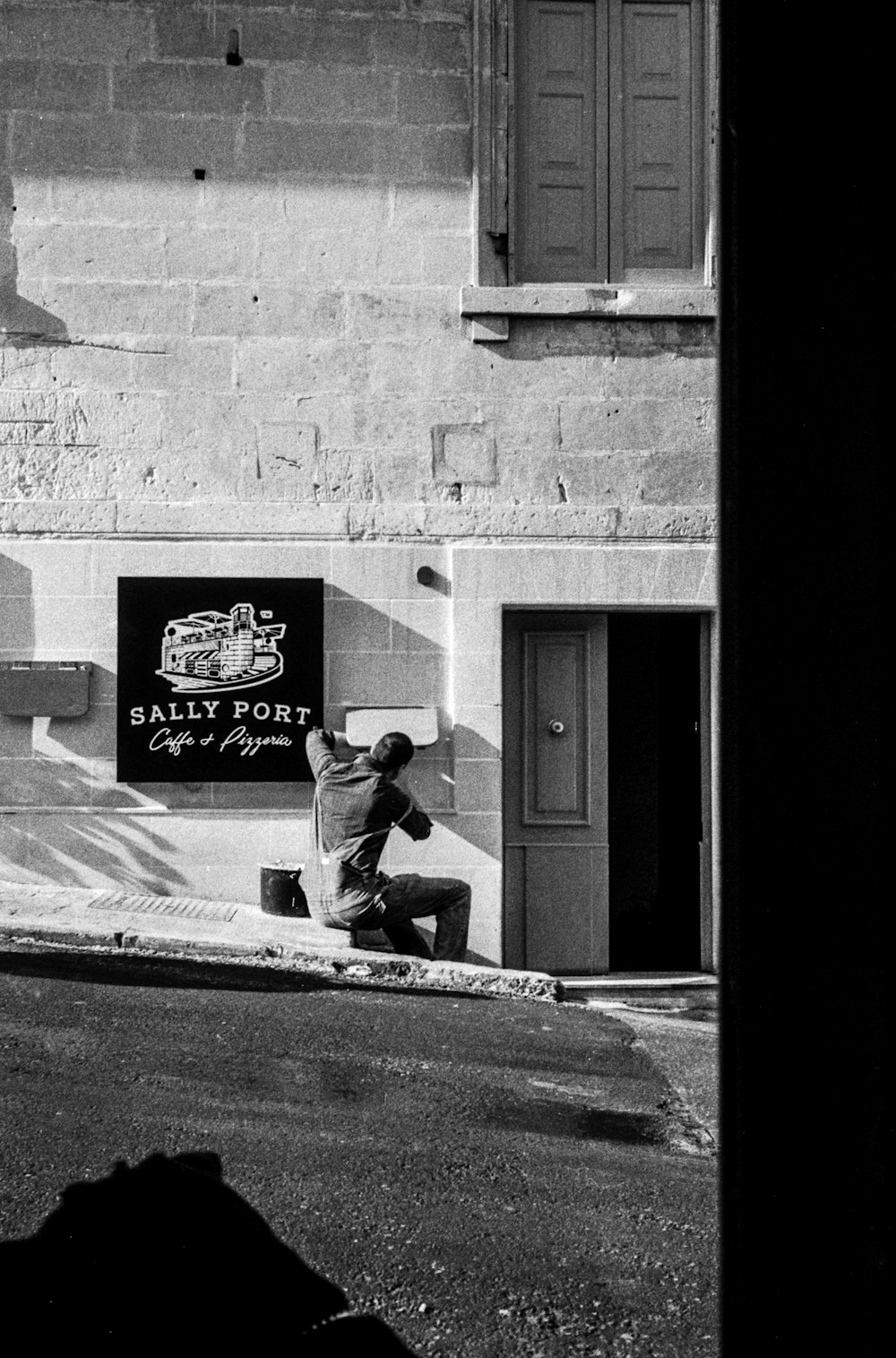 man in black jacket sitting on the floor