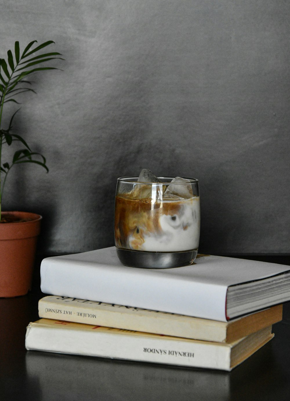 clear glass cup on book