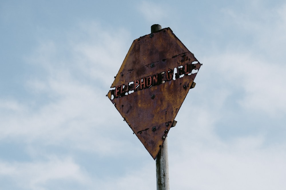 brown and white wooden street sign