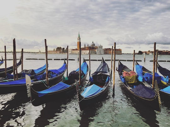 blue and brown boat on water during daytime in Church of San Giorgio Maggiore Italy