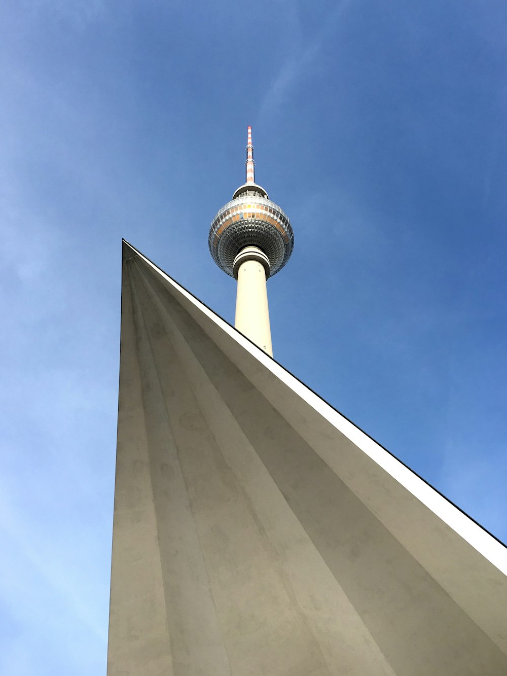 Weißer Betonturm tagsüber unter blauem Himmel