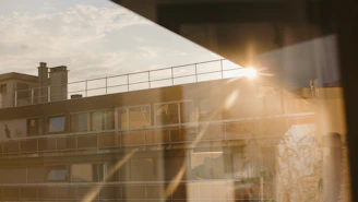 Sunlight streaming through spotless windows of a high-rise building maintained by švaros tiltas team.