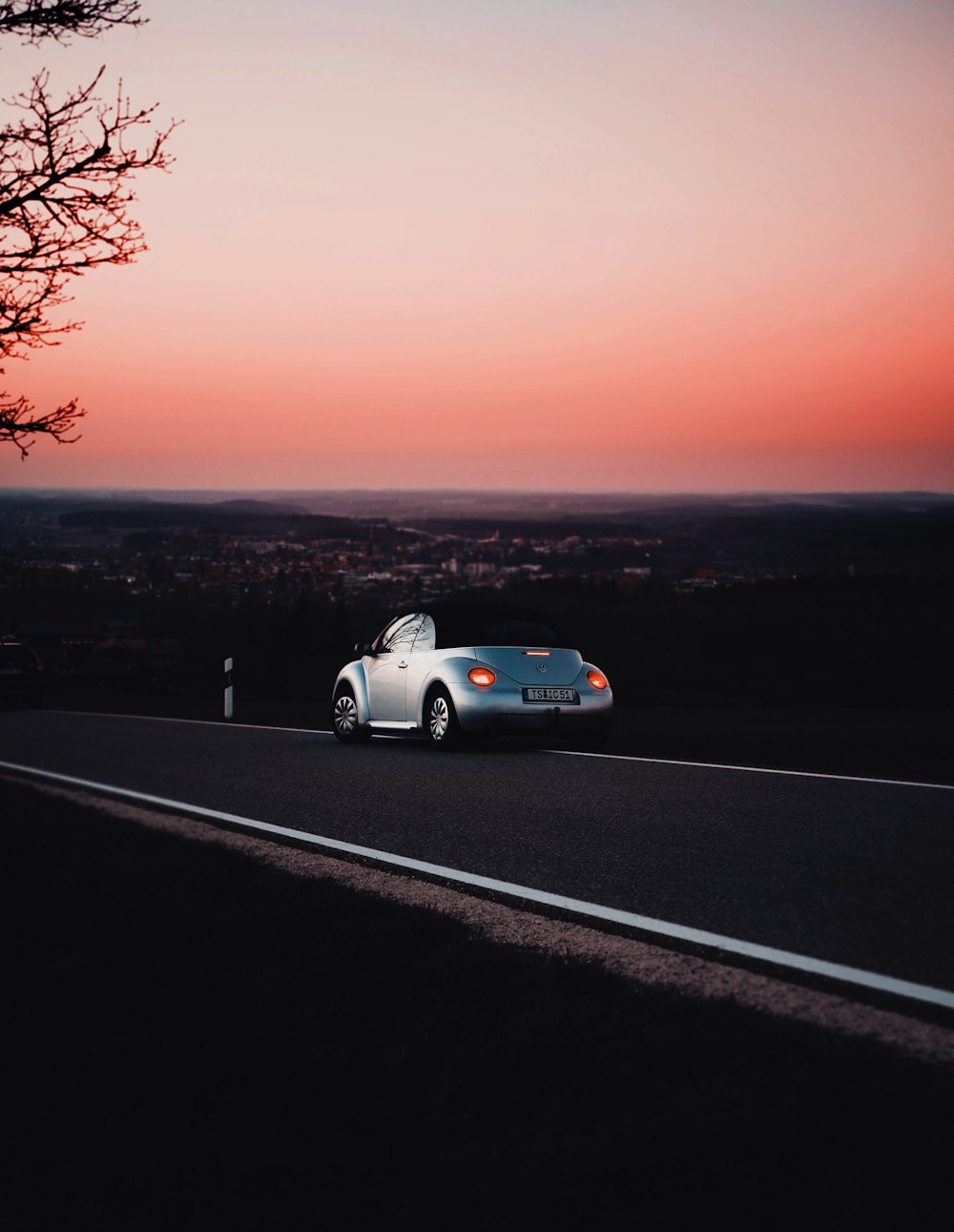 white coupe on snow covered ground during daytime