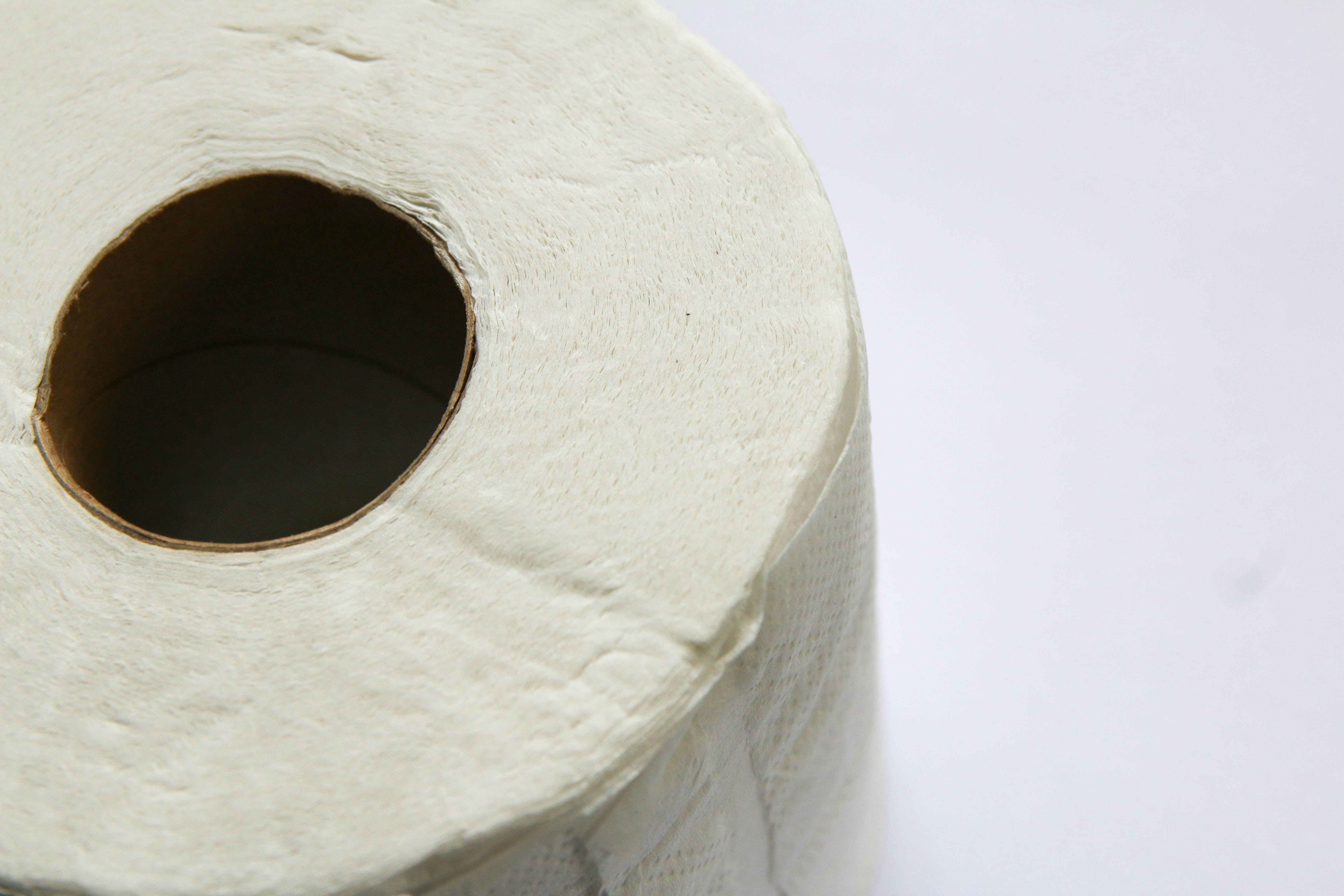 white toilet paper roll on white table