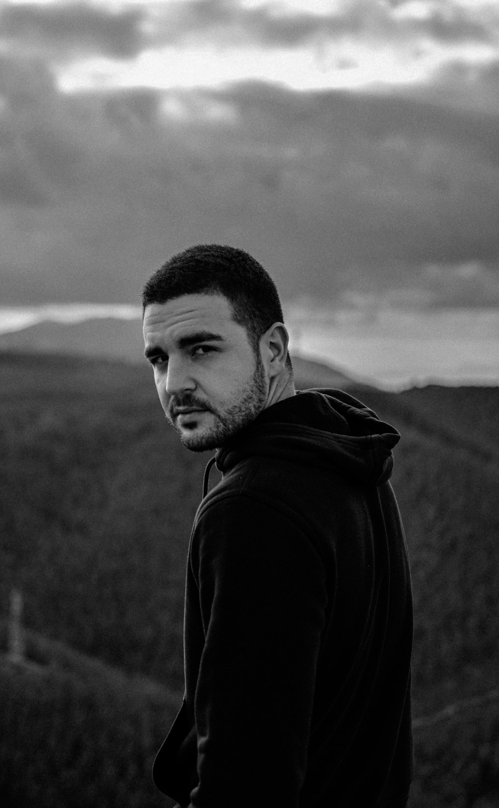 man in black hoodie in grayscale photography