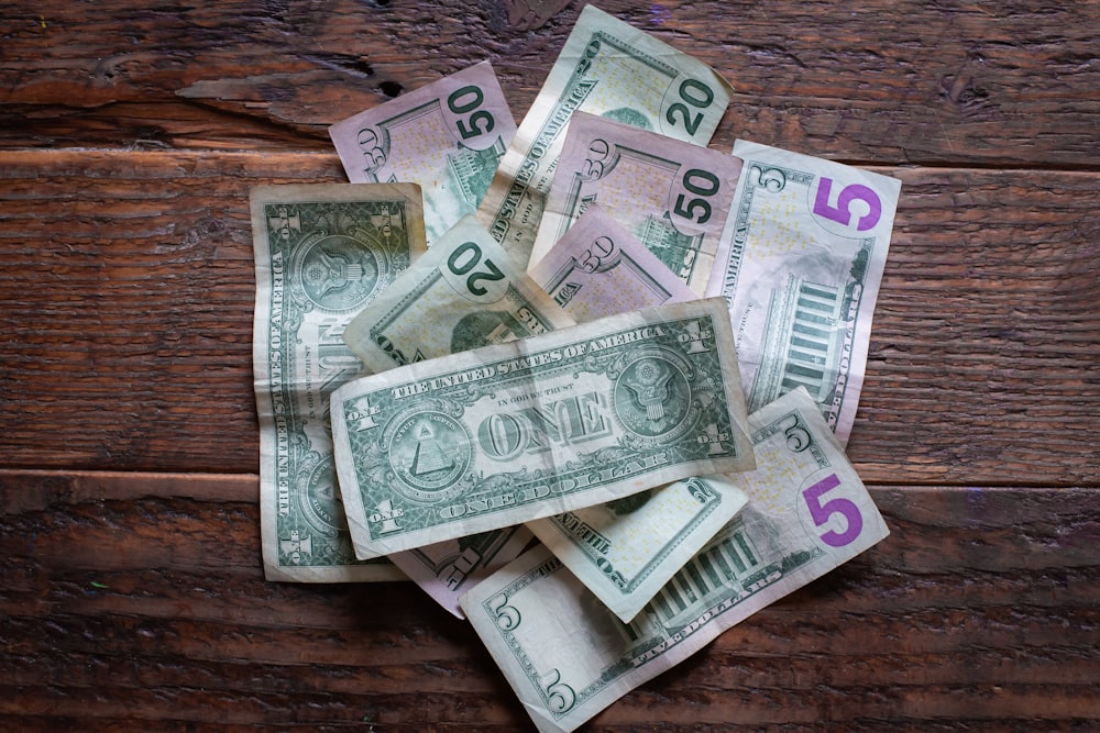 10 and 20 banknotes on brown wooden table