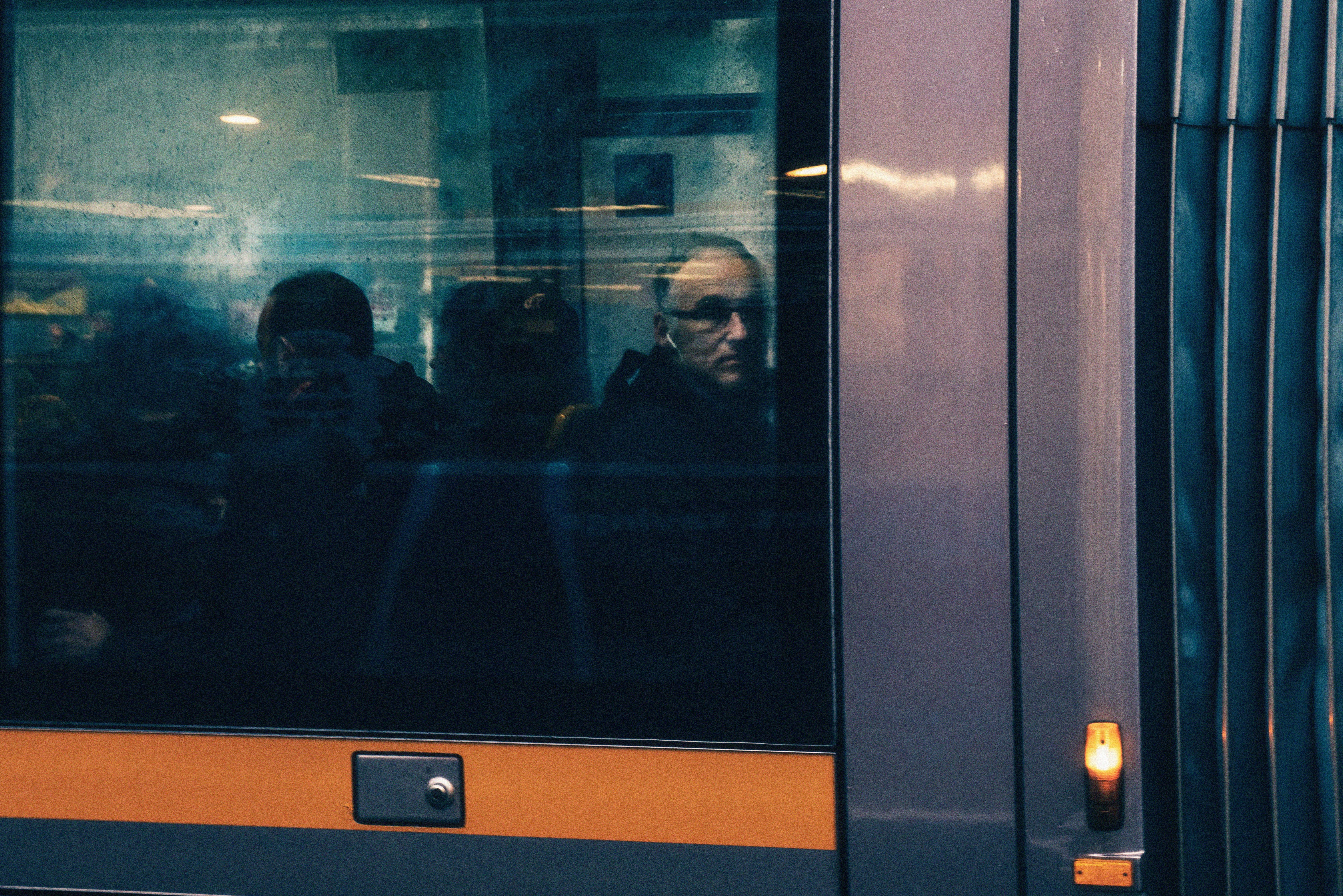 man in black jacket sitting on train seat, The Commuter
