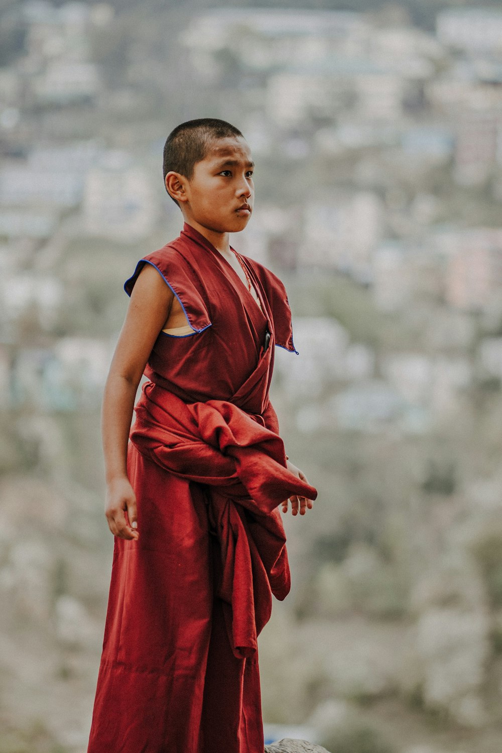 girl in red dress standing on field during daytime