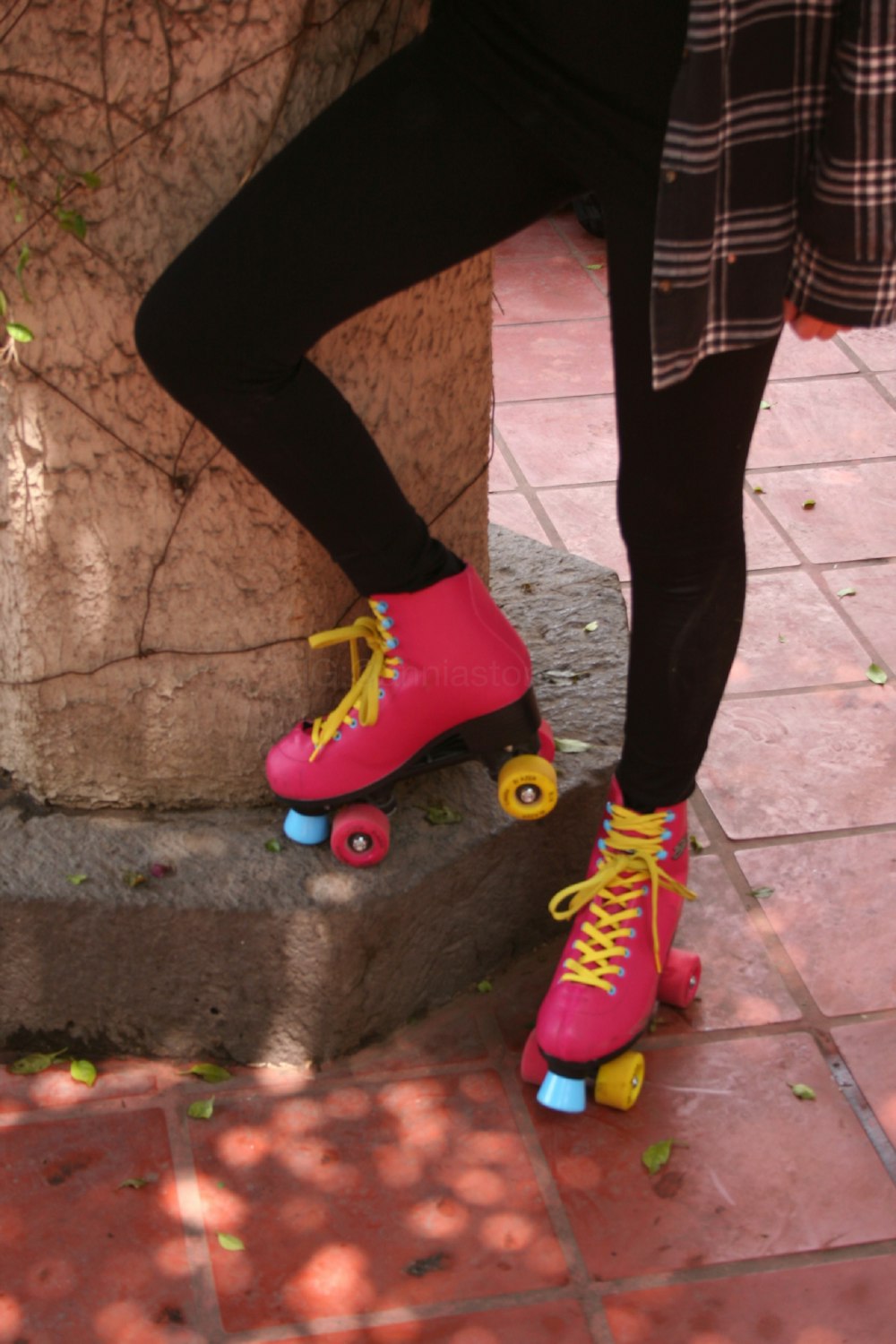 woman in black pants and pink and green boots