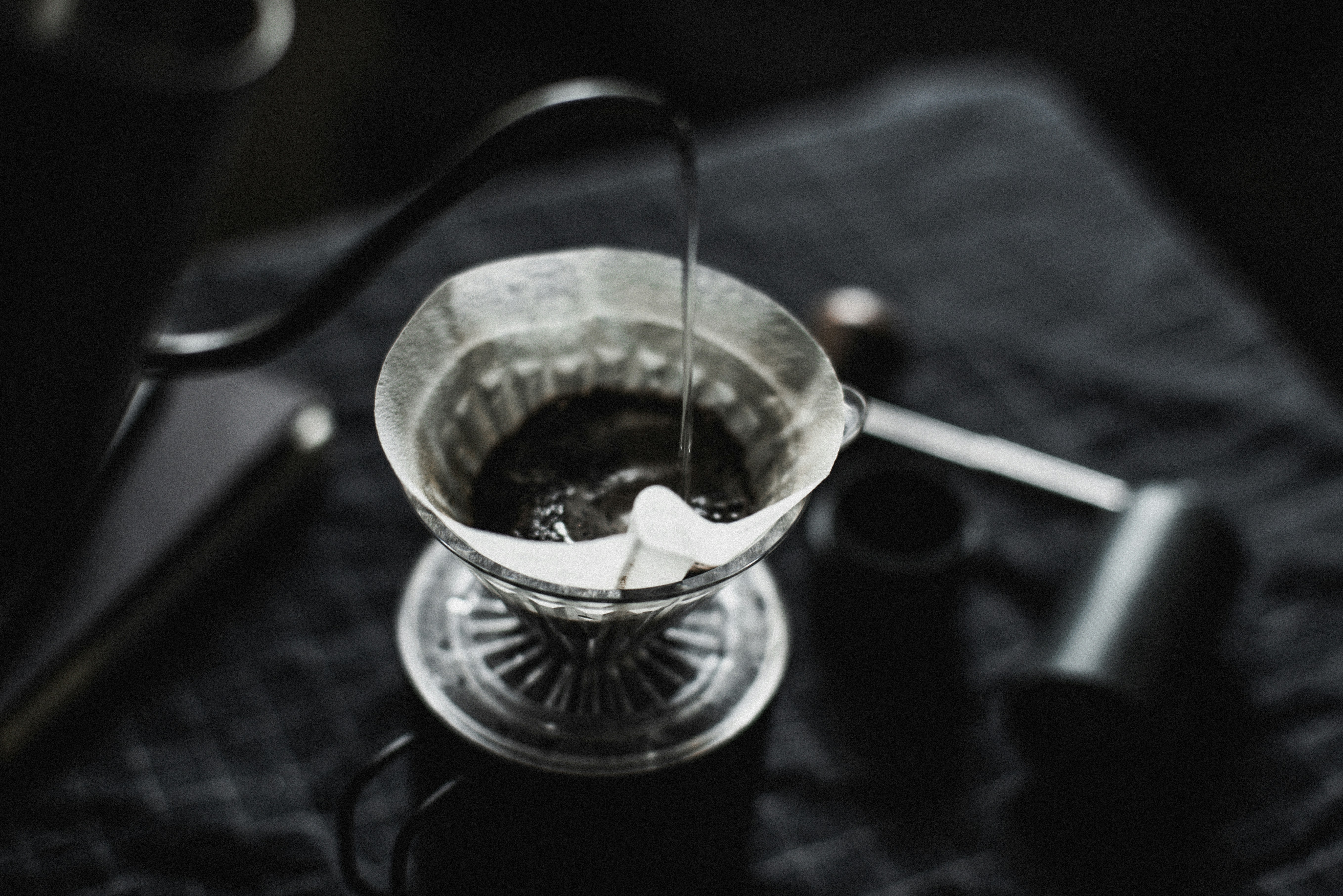 Pour-over dripper on a glass in a dark setting