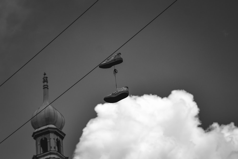 grayscale photo of 2 birds flying over the clouds