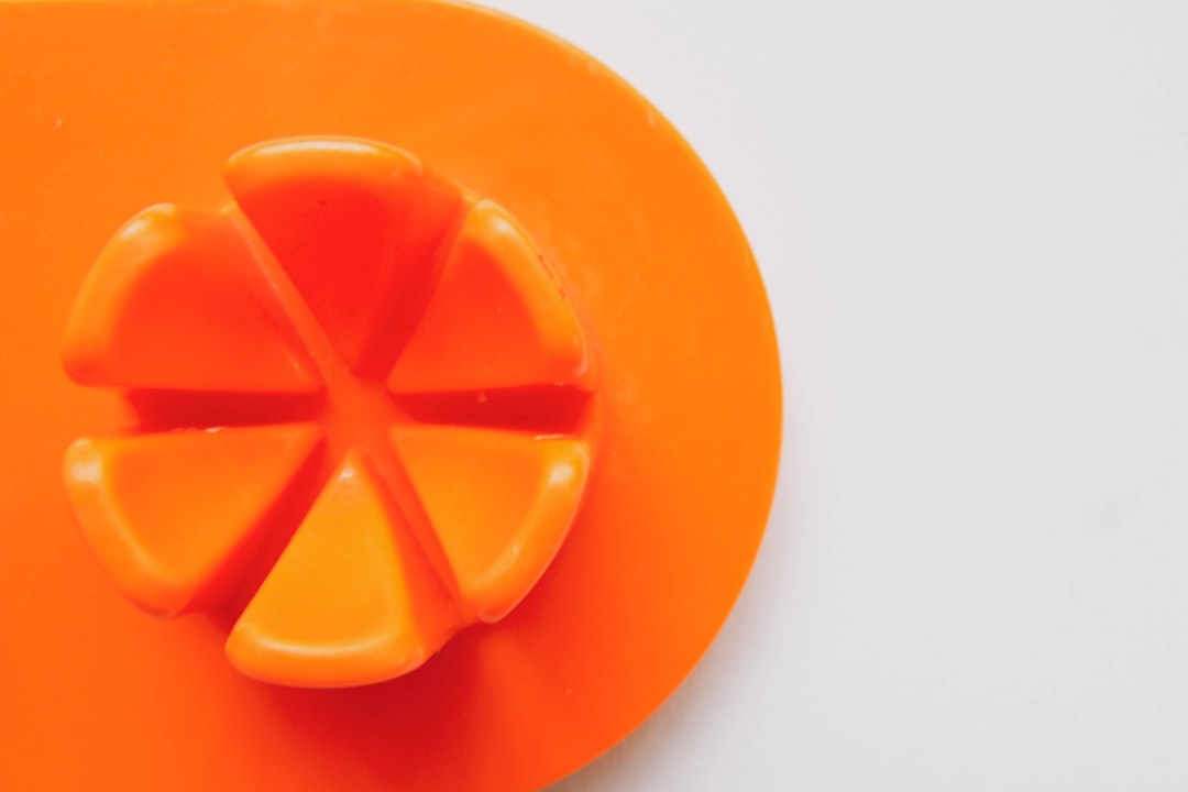 orange round plastic on white surface