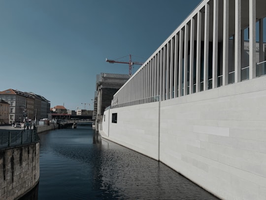 white and black concrete building near body of water during daytime in German Historical Museum Germany