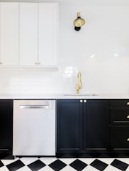 Sleek modern kitchen cabinet in black and gold accents.