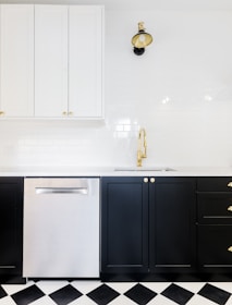 Spacious kitchen with sleek black and gold finishes in a stylish home.