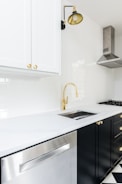 white wooden kitchen cabinet near white wooden kitchen cabinet