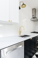 white wooden kitchen cabinet near white wooden kitchen cabinet