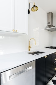 white wooden kitchen cabinet near white wooden kitchen cabinet