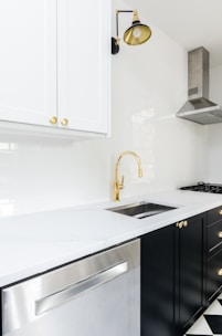 white wooden kitchen cabinet near white wooden kitchen cabinet