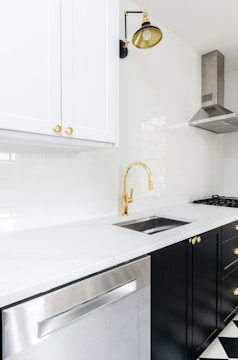 white wooden kitchen cabinet near white wooden kitchen cabinet