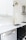 white wooden kitchen cabinet near white wooden kitchen cabinet