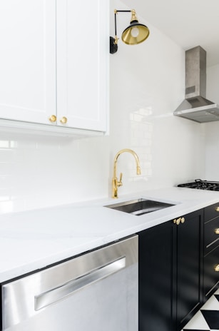 white wooden kitchen cabinet near white wooden kitchen cabinet