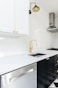 white wooden kitchen cabinet near white wooden kitchen cabinet