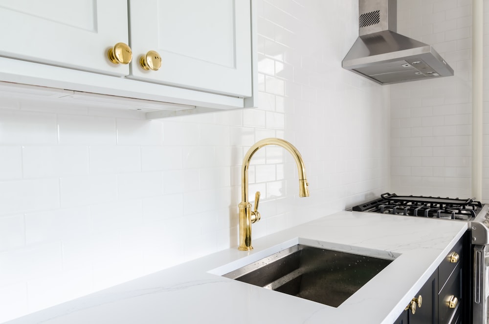 white wooden door beside stainless steel sink