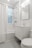 white ceramic bathtub near white bathtub