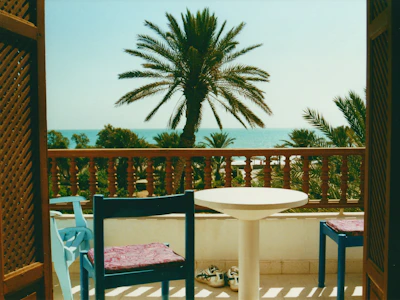 Balcony with sea view and comfortable outdoor furniture.