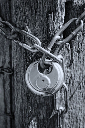 gray scale photo of chain link fence