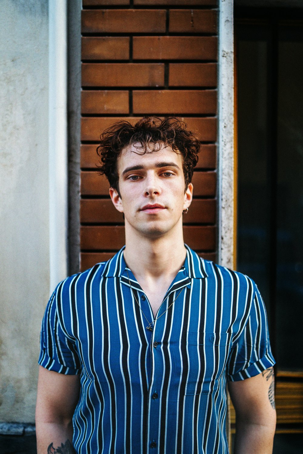 man in blue and white striped button up shirt