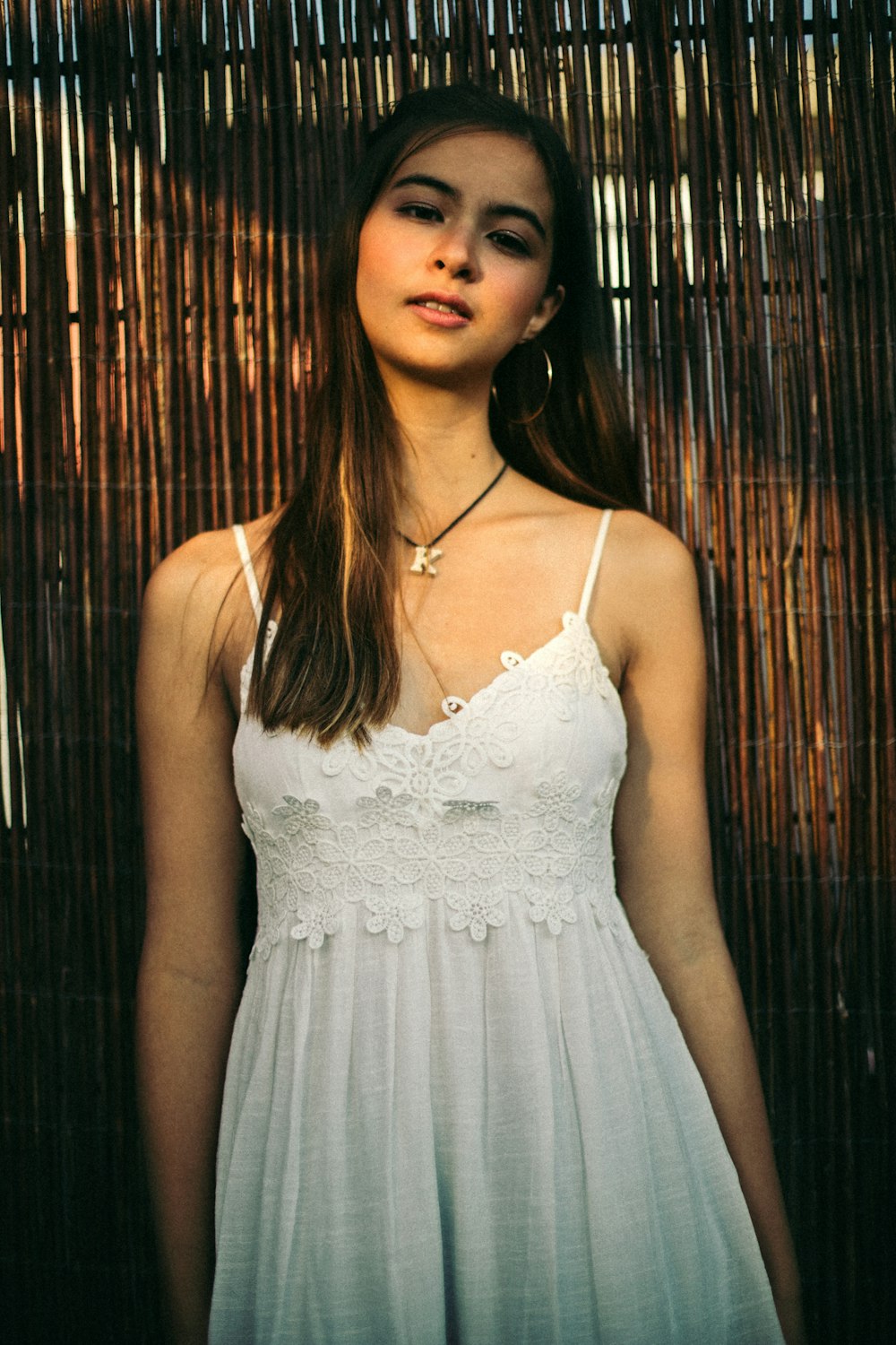 woman in white spaghetti strap dress