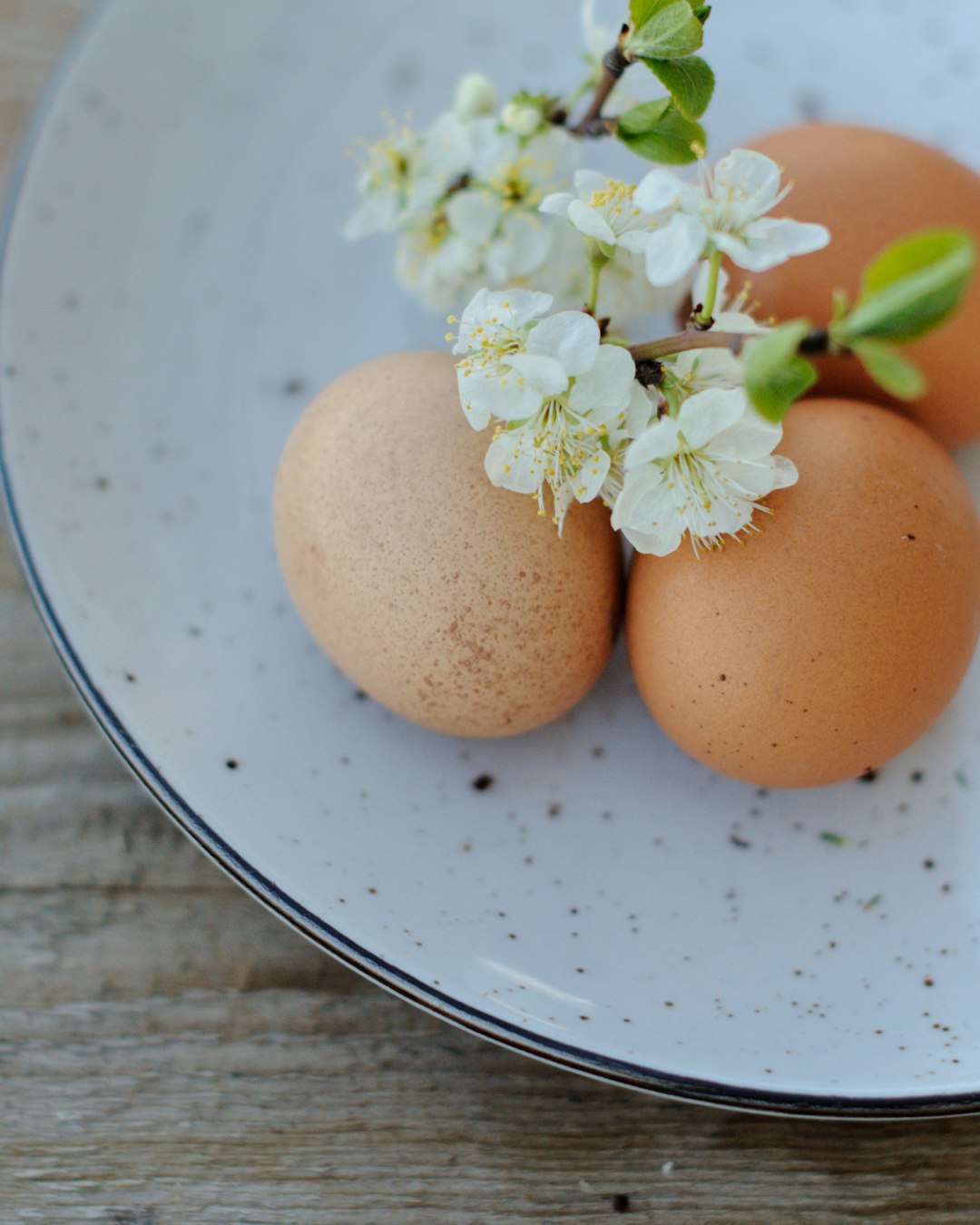 2 brown eggs on white ceramic plate