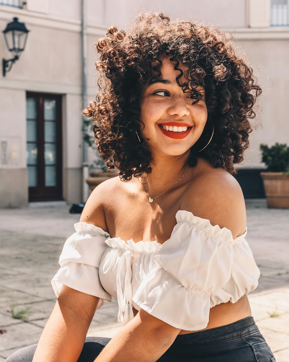 smiling woman in white off shoulder dress