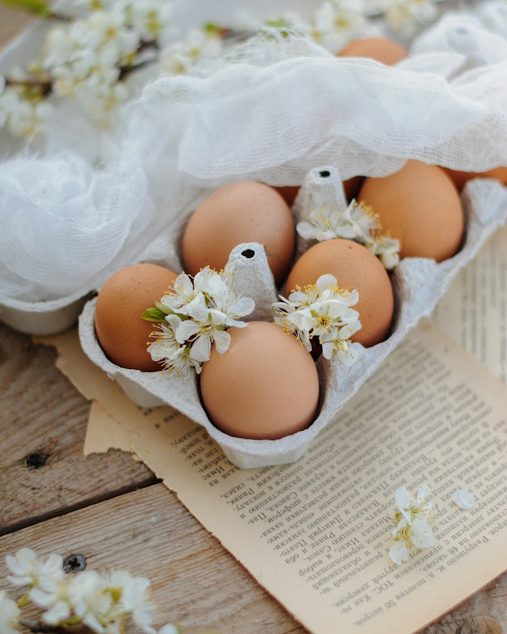 2 brown eggs on white textile