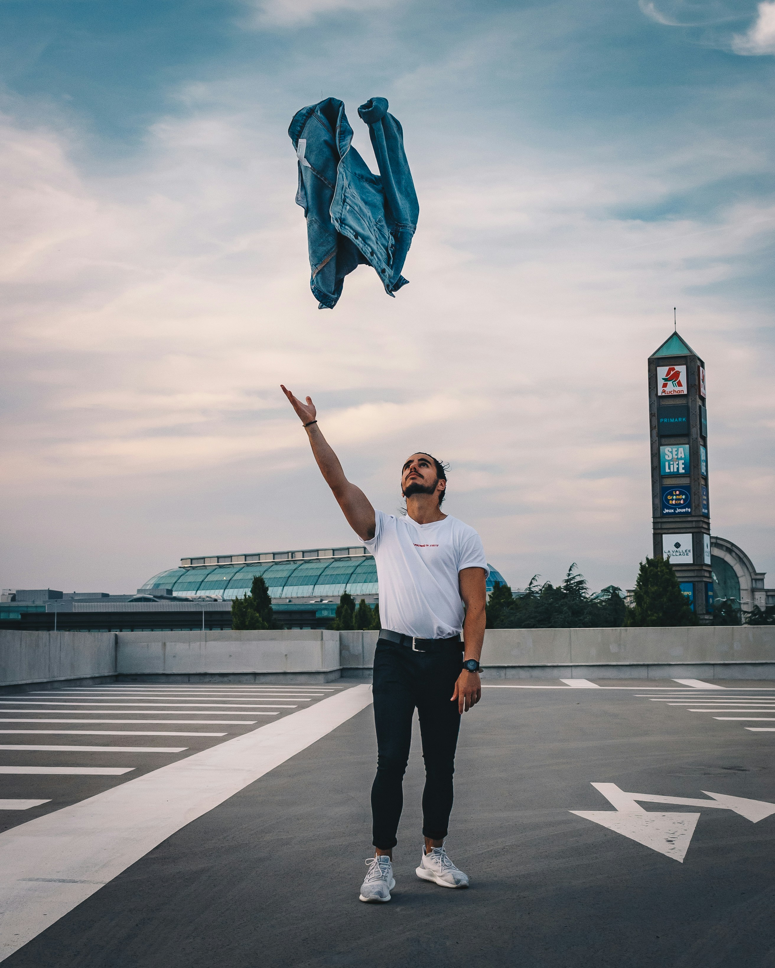 man in white t-shirt and black shorts running on road during daytime