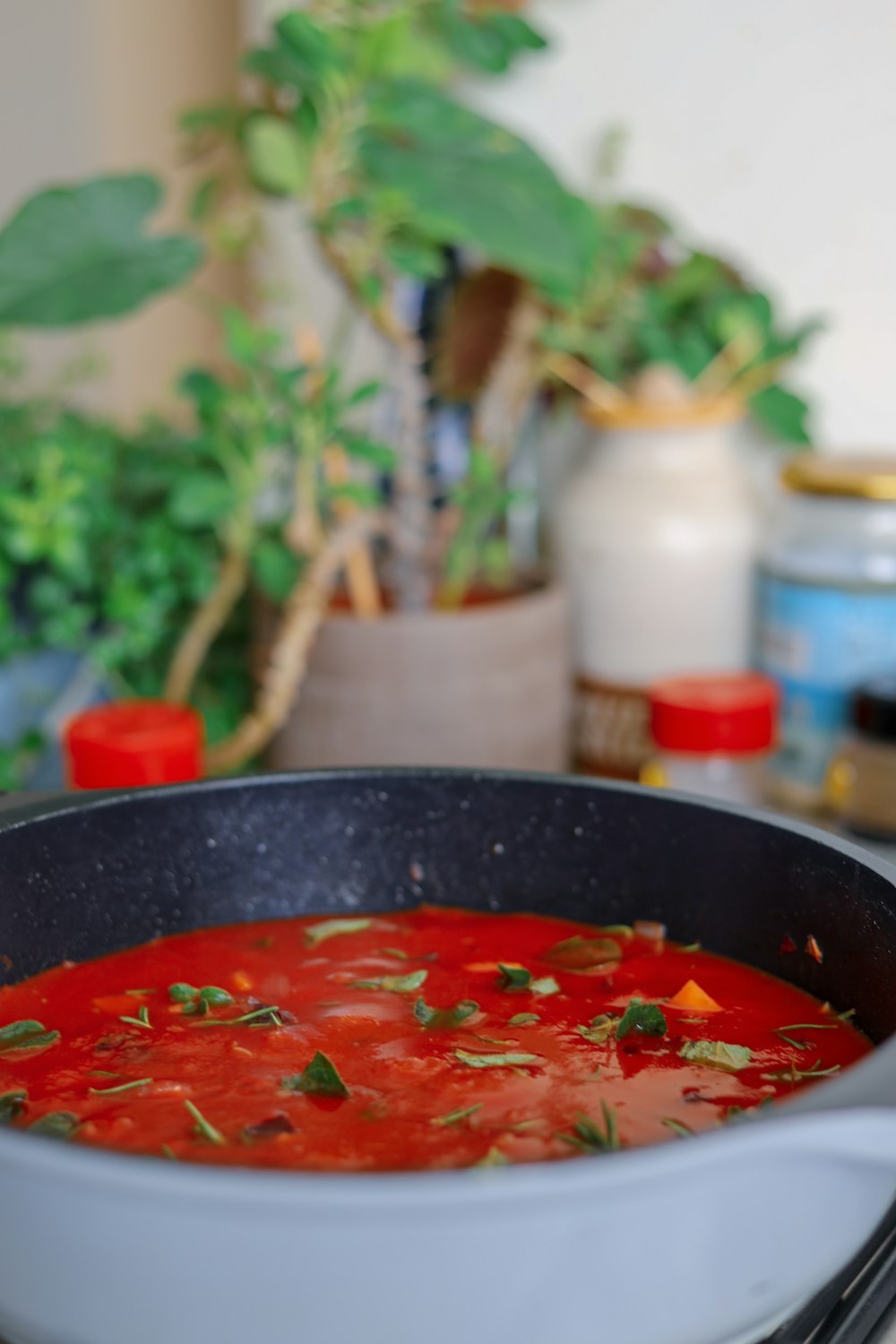 red soup in black ceramic bowl