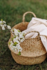 white flowers in brown woven basket