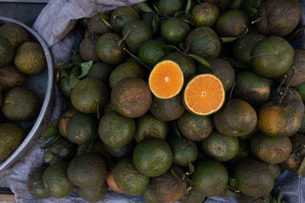 orange fruit on green fruits