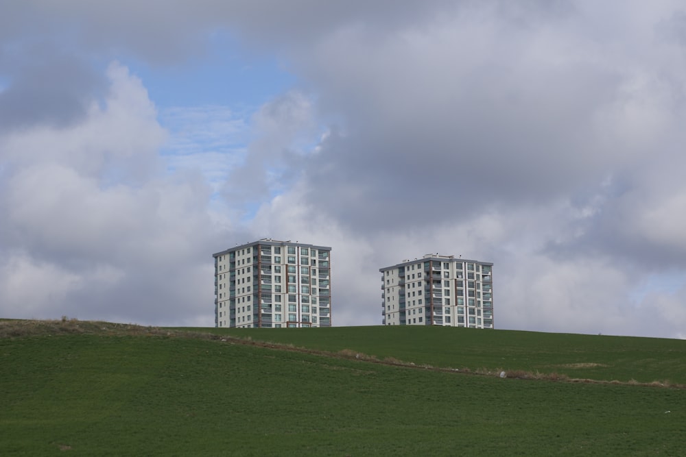 green grass field under cloudy sky during daytime